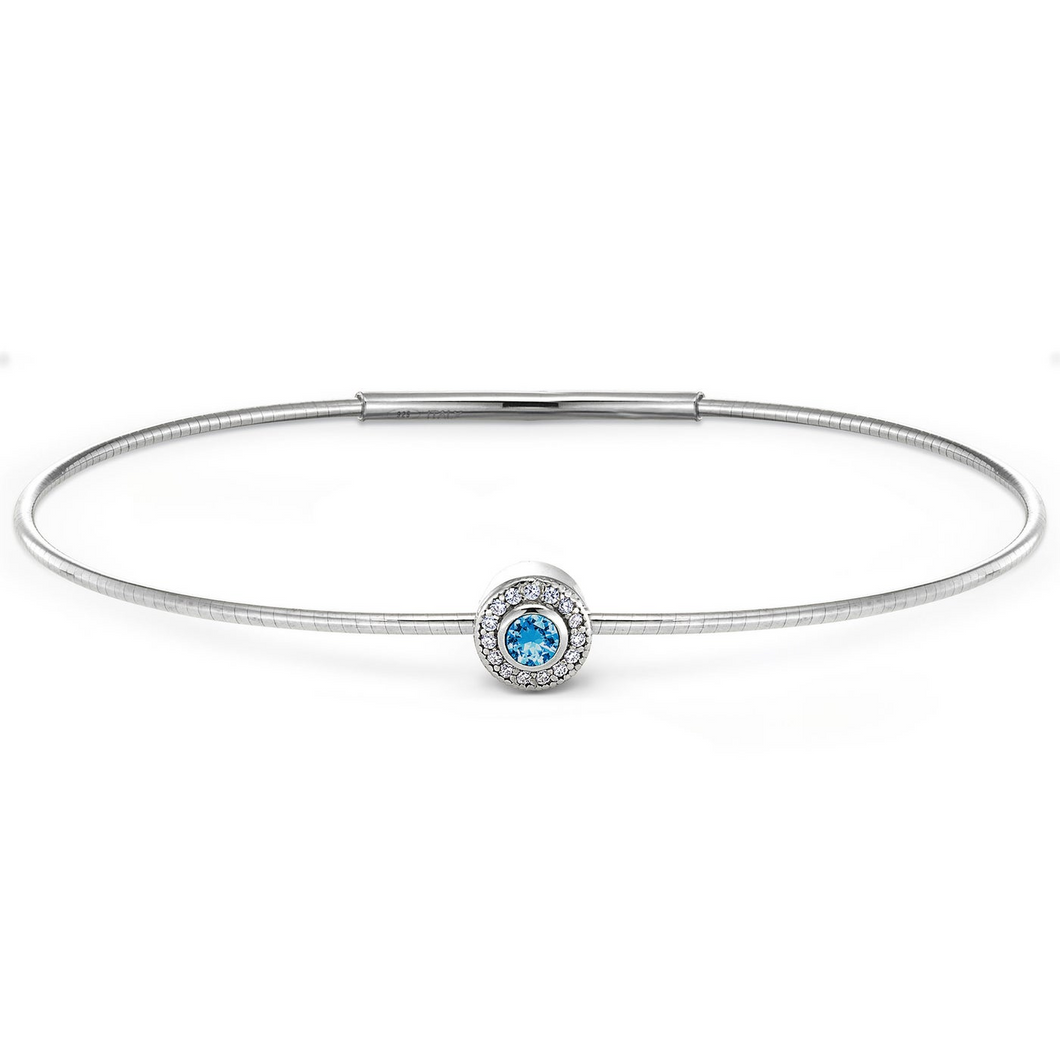 sterling silver flexible bracelet with round sterling charm containing simulated diamonds and simulated blue topaz