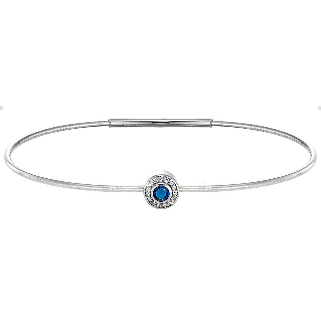 Sterling silver flexible bracelet with round sterling charm containing simulated diamonds and simulated sapphire